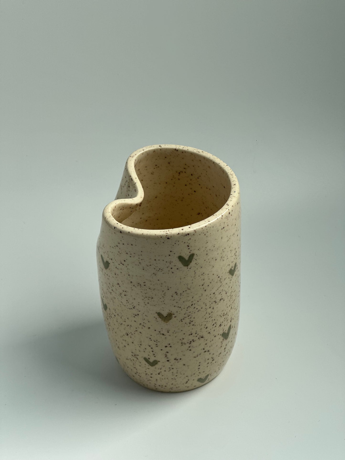 Ceramic cup with green hearts